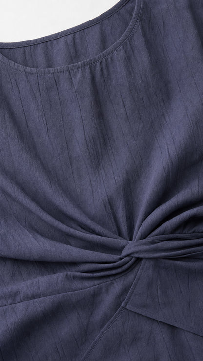 Close-up detail of textured slub fabric and front twist crossover knot design