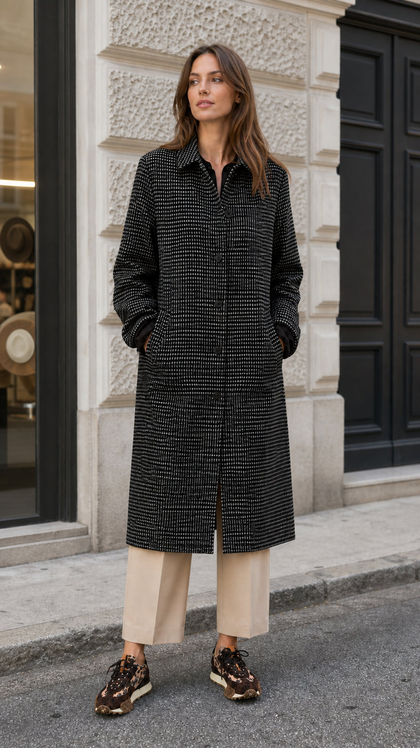 Woman modeling black and white houndstooth long tailored overcoat