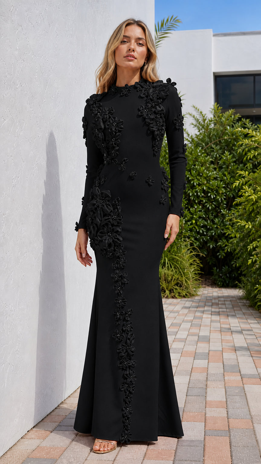 Front view of model wearing black long sleeve evening gown
