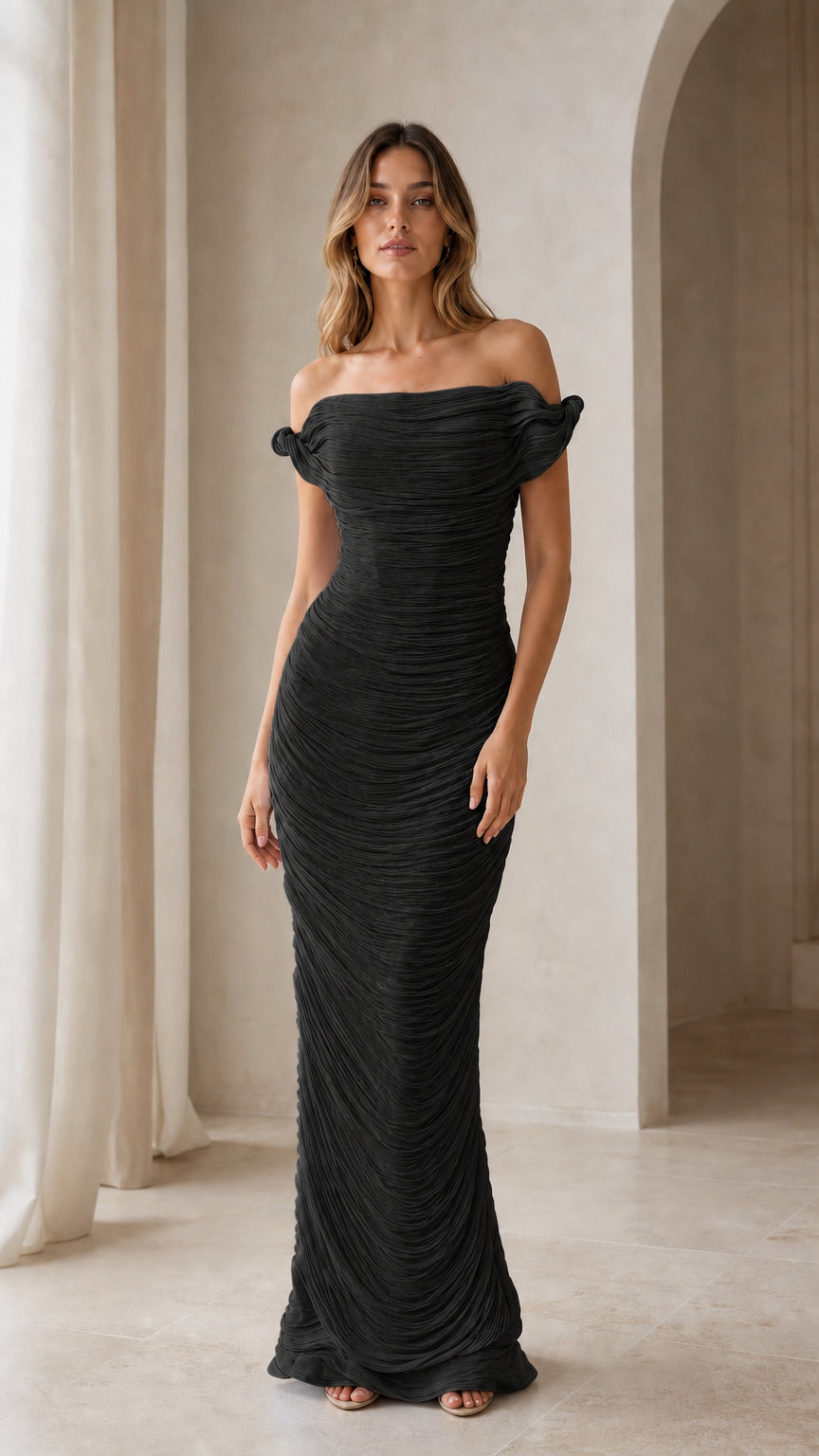 Model wearing black evening gown with off-shoulder design