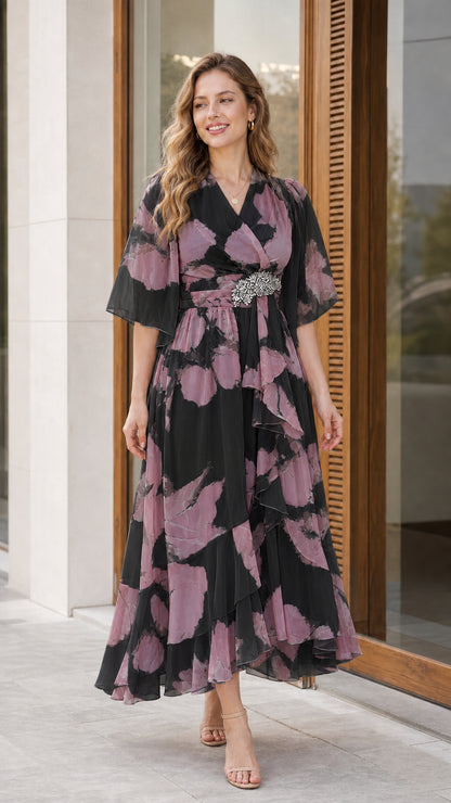 Woman wearing black floral chiffon flutter sleeve midi dress with crystal waist detail
