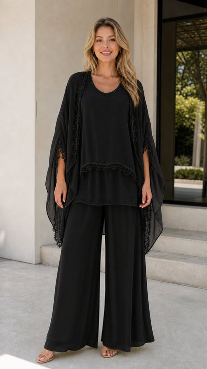 Model wearing black chiffon 3-piece pants set with cape