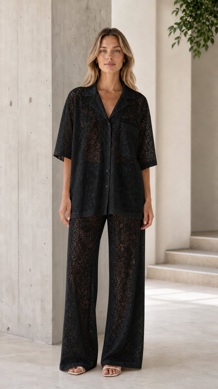 Front view of woman wearing black lace shirt and pants set