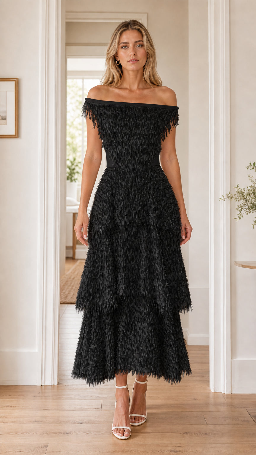 Front view of woman in black off-the-shoulder fringe dress