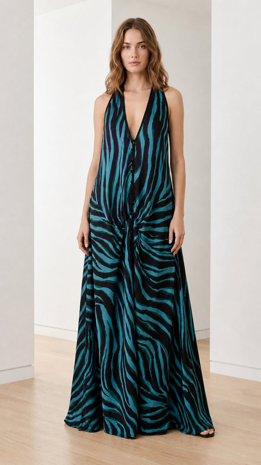 Woman wearing teal and black zebra print halter maxi dress