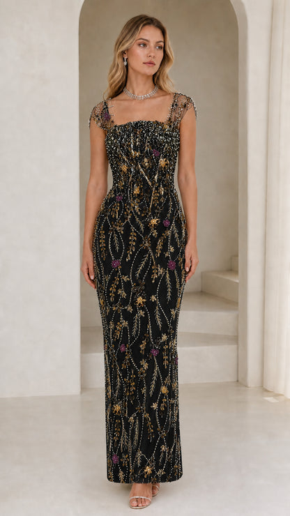 Front view of model wearing black beaded evening gown