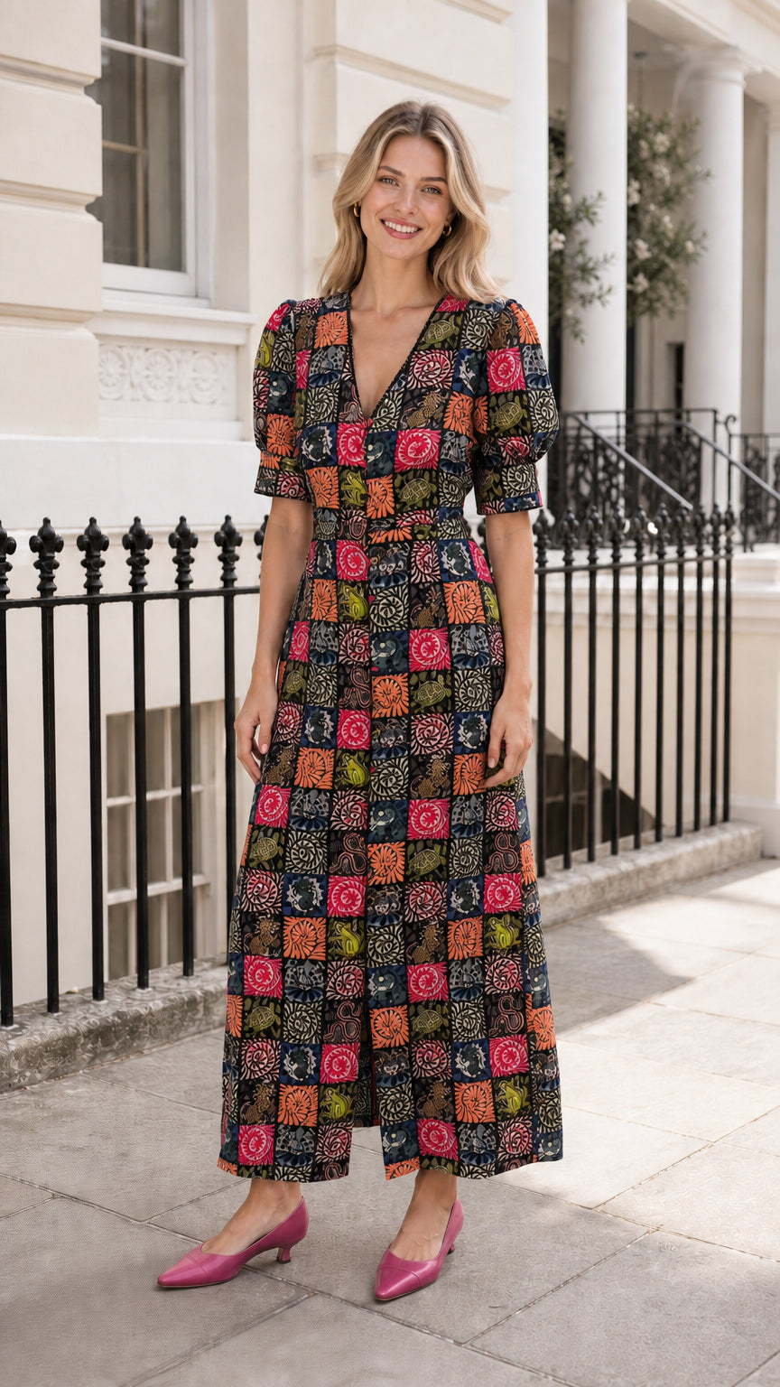Woman wearing black-based patchwork midi dress outdoors