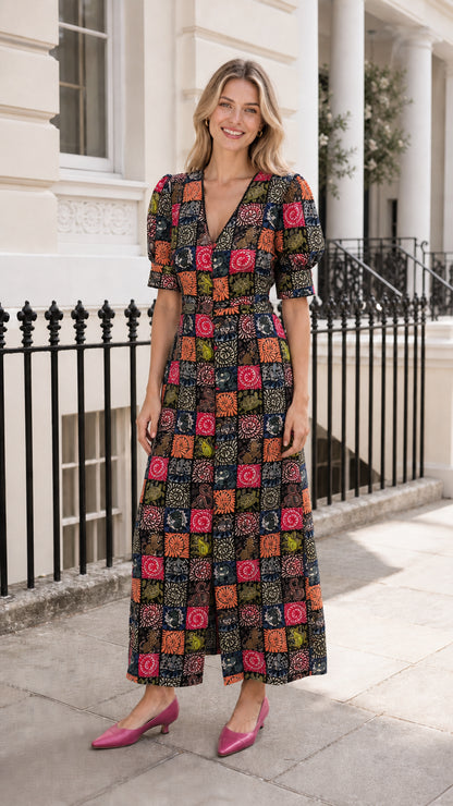 Woman wearing black-based patchwork midi dress outdoors