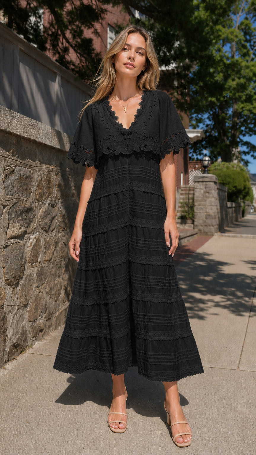 Full view of woman wearing black eyelet lace cape sleeve maxi dress