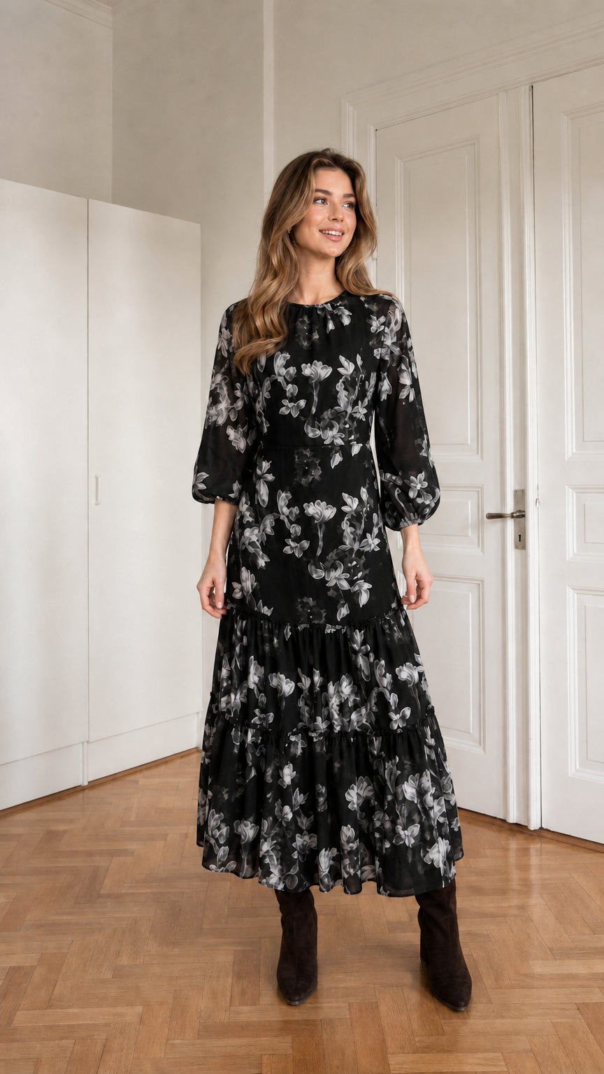 Woman wearing black floral print long sleeve tiered midi dress