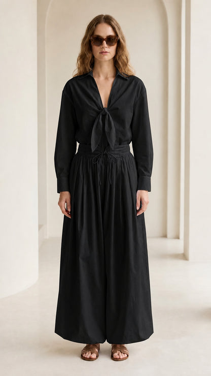 Woman wearing black tie-front shirt and wide-leg pants set