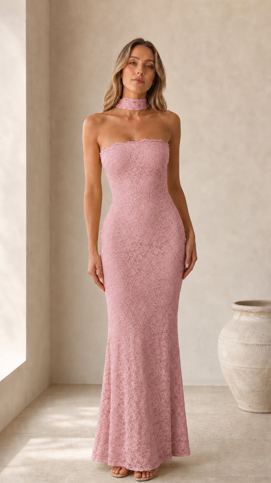 Front view of model wearing pink strapless lace maxi dress