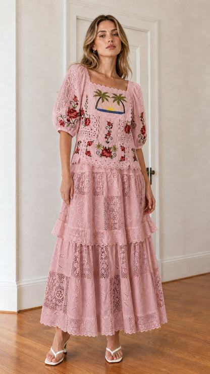 Front view of woman wearing pink embroidered maxi dress