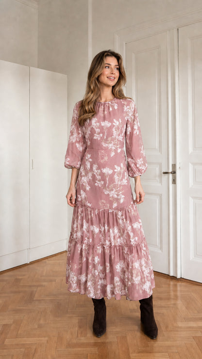Woman wearing pink floral print long sleeve tiered midi dress