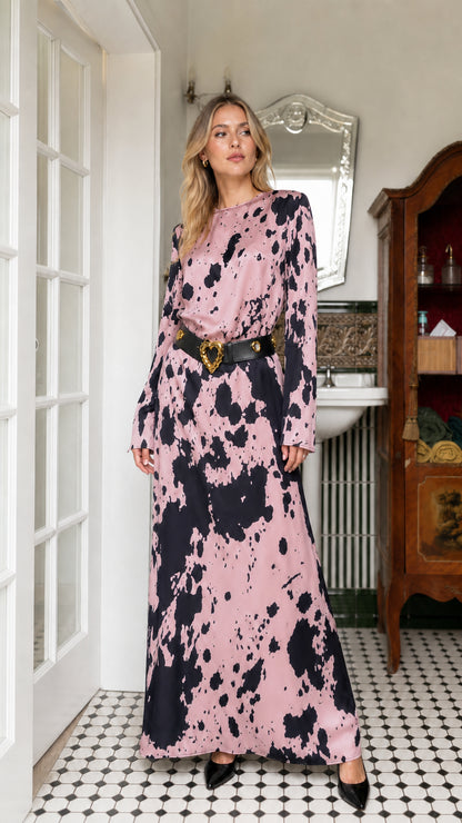 Woman wearing pink cow print long sleeve maxi dress with belt