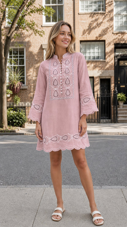 Model wearing pink embroidered mini dress