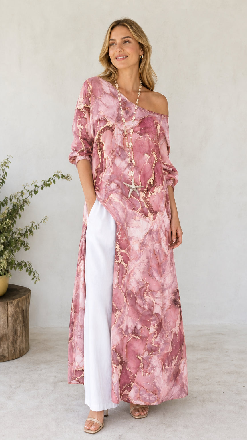 Model wearing pink marble print off-shoulder maxi tunic with white pants
