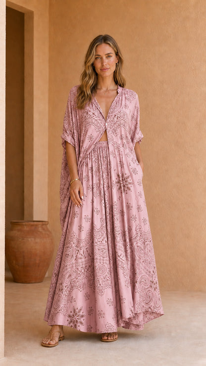 Model wearing pink printed two-piece kaftan and maxi skirt set