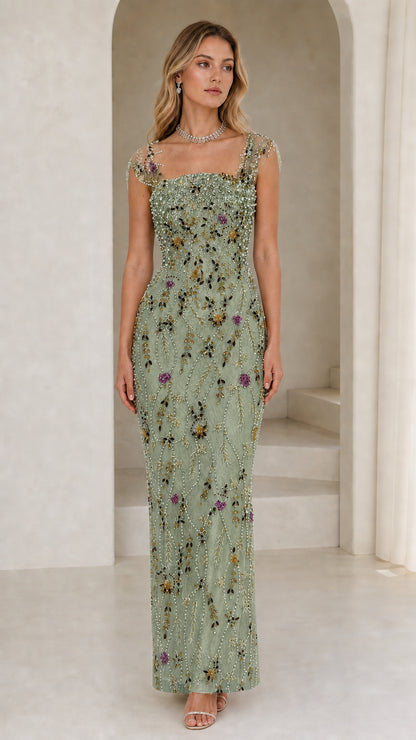 Front view of model wearing sage green beaded evening gown
