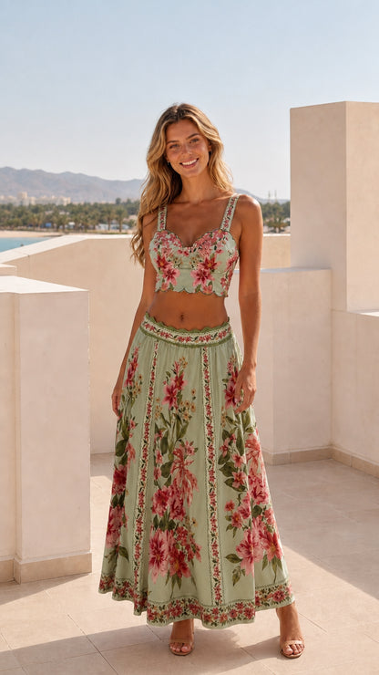 Model wearing sage green floral two-piece crop top and maxi skirt set