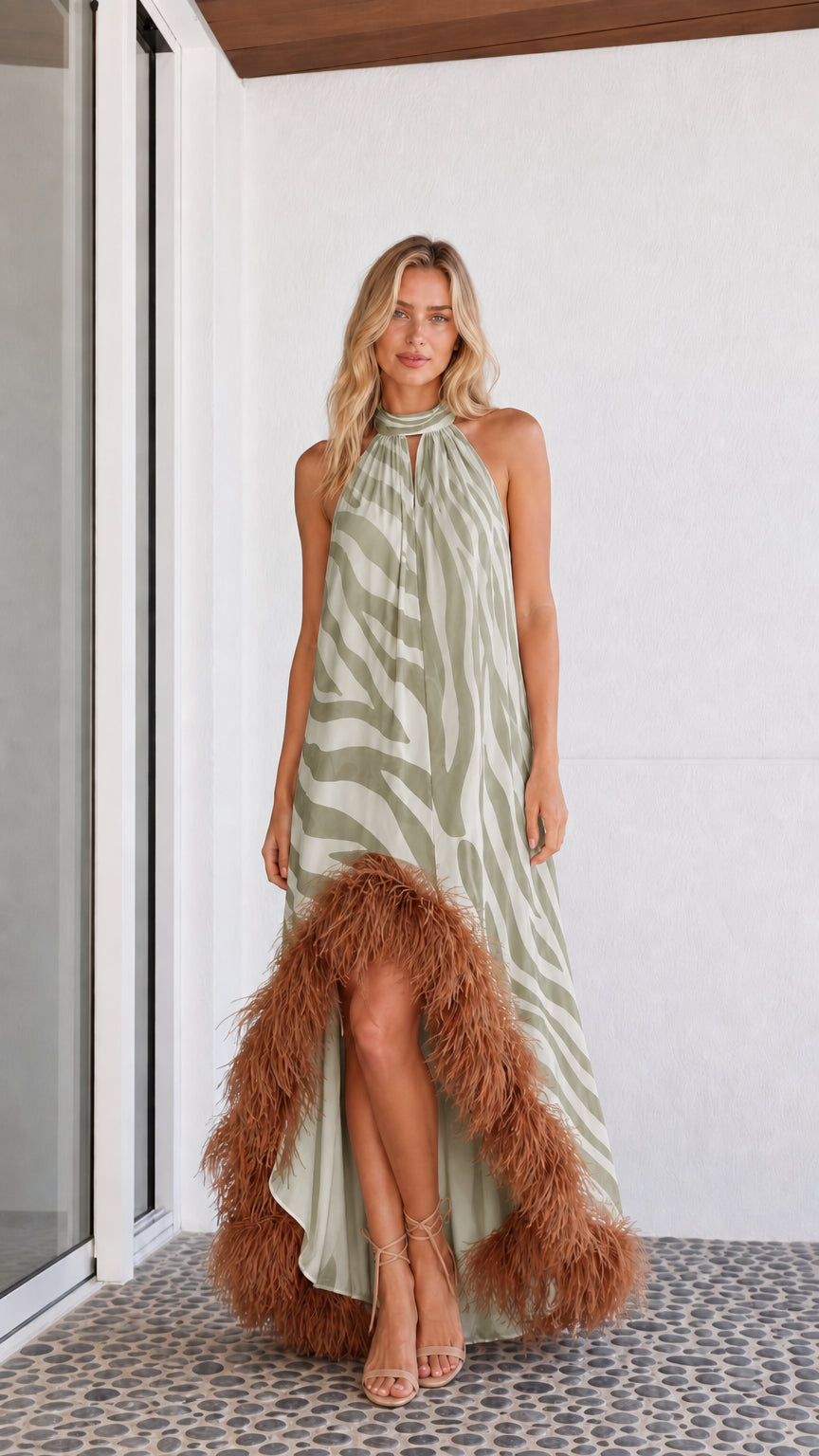 Model wearing sage green zebra print maxi dress with feather hem
