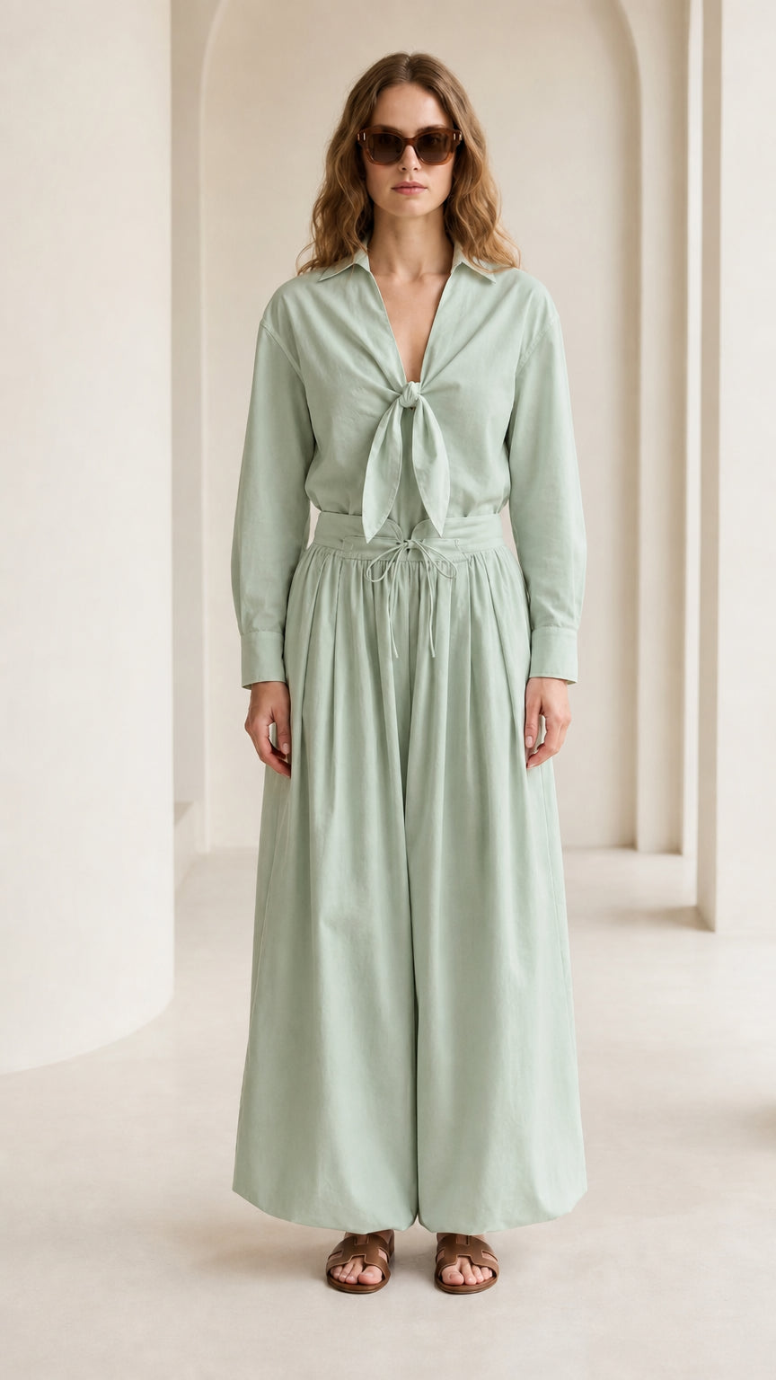 Woman wearing sage green tie-front shirt and wide-leg pants set