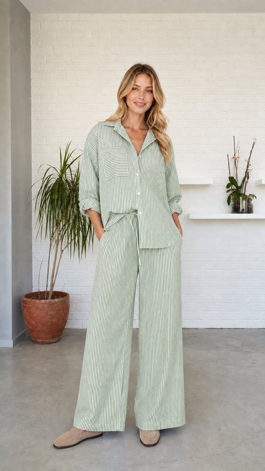 Woman wearing green striped button-down shirt and wide-leg pants