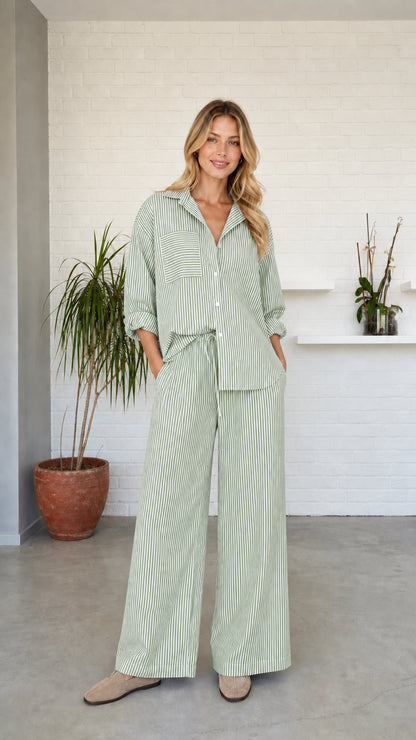 Woman wearing green striped button-down shirt and wide-leg pants