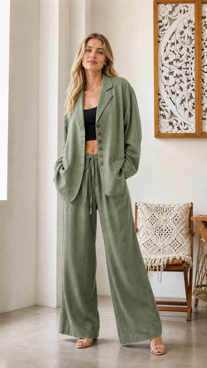 Model wearing sage green blazer and wide-leg pants set