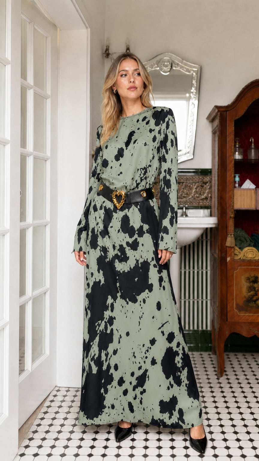 Woman wearing sage green cow print long sleeve maxi dress with belt