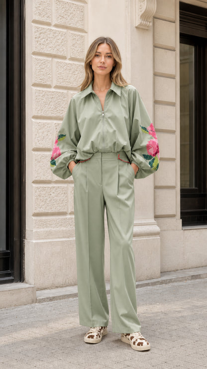 Model wearing sage green matching jacket and wide-leg pant set with floral embroidery