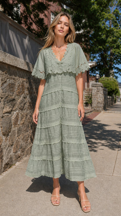 Full view of woman wearing sage green eyelet lace cape sleeve maxi dress