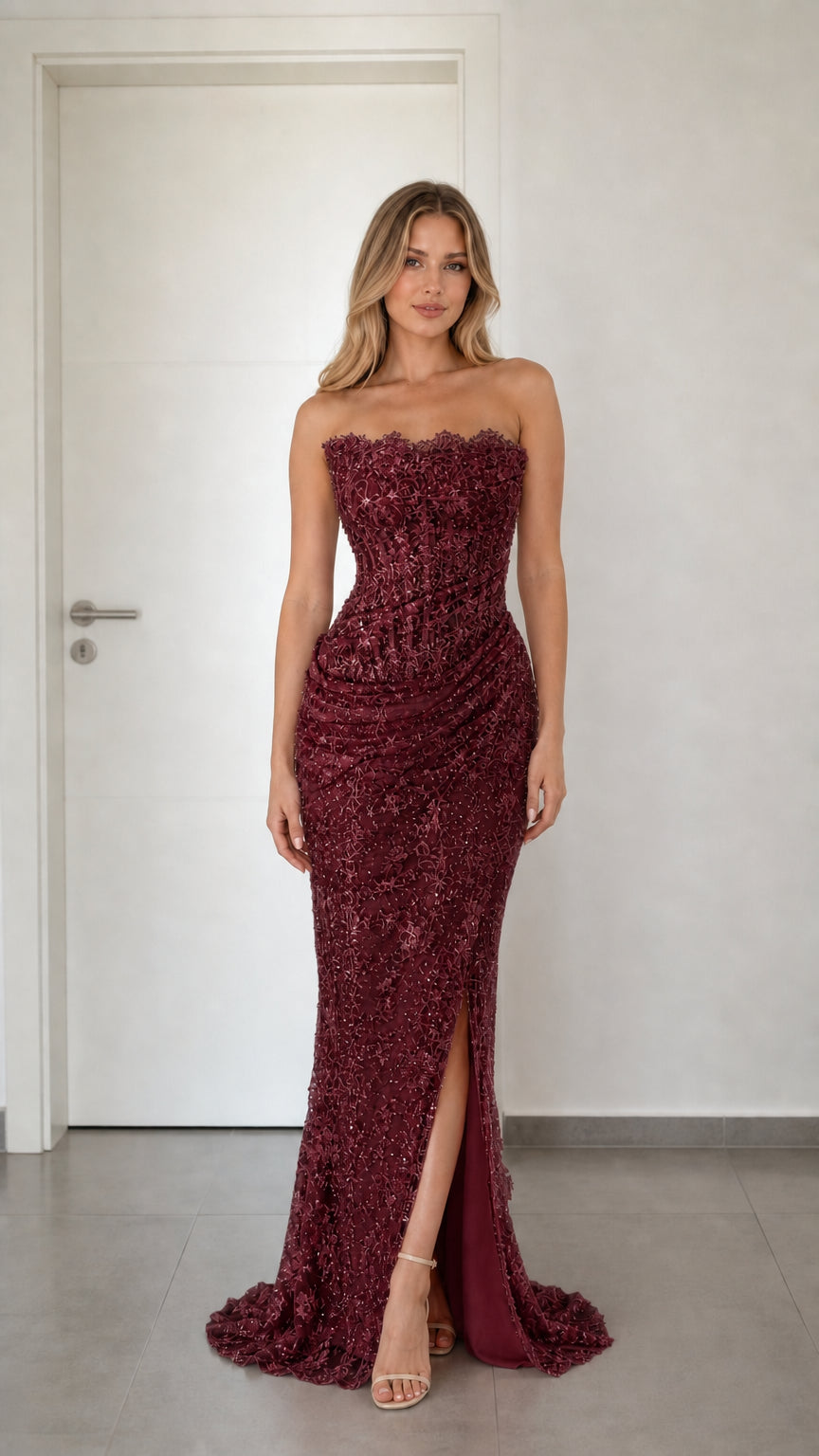 Front view of burgundy strapless sequin lace formal evening dress with high slit