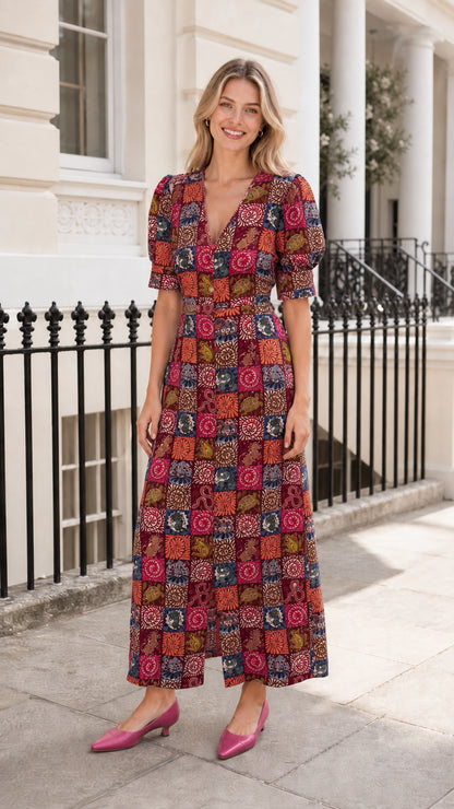 Woman wearing burgundy-based patchwork midi dress outdoors