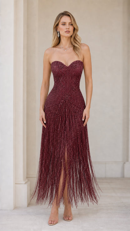 Front view of model wearing the burgundy color variant of the beaded fringe gown