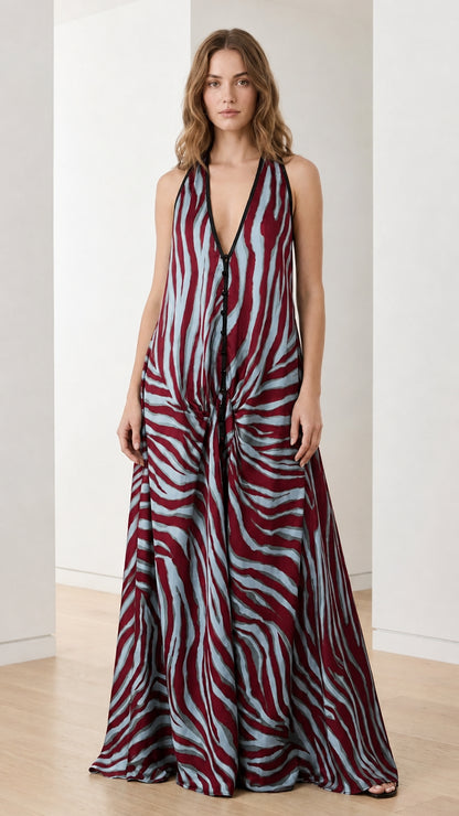 Woman wearing burgundy and blue zebra print halter maxi dress