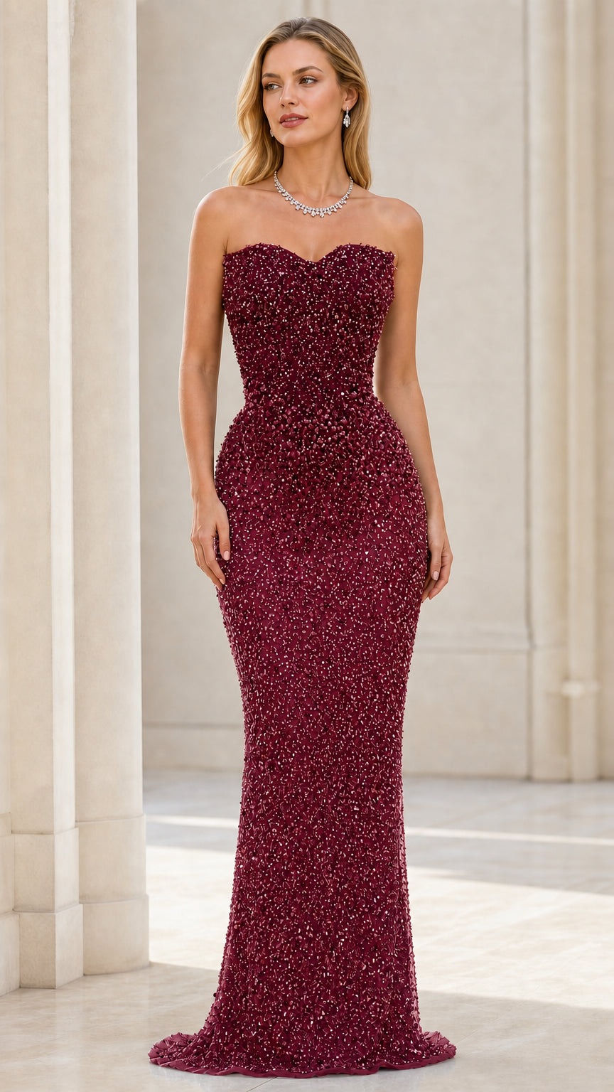 Front view of model wearing burgundy beaded strapless mermaid evening gown