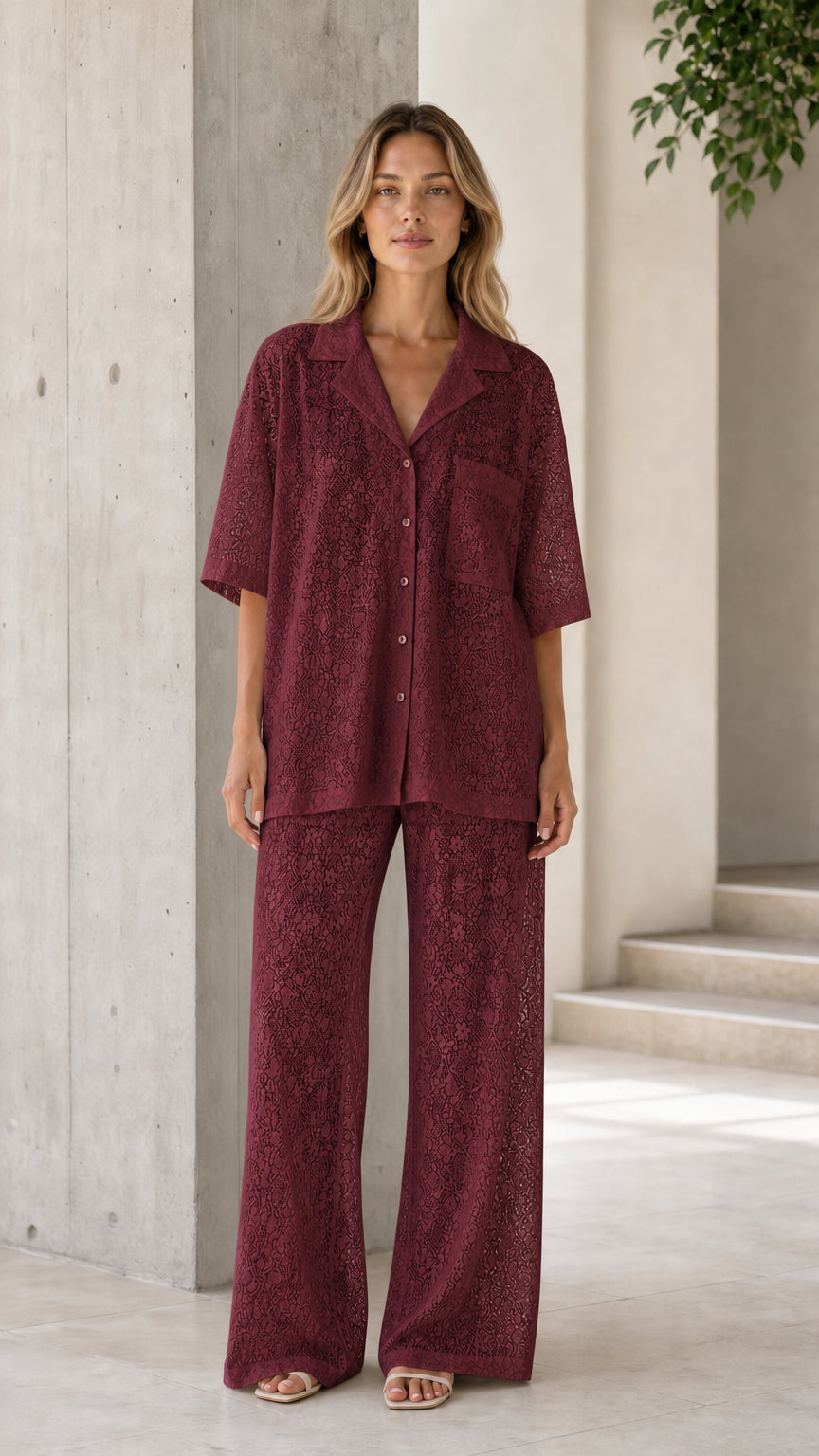 Front view of woman wearing burgundy lace shirt and pants set