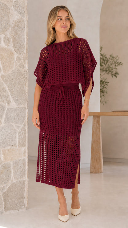 Model wearing burgundy open-knit two piece skirt set