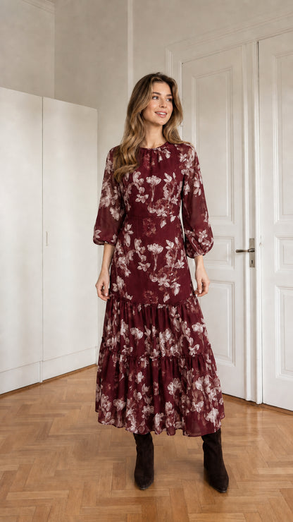 Woman wearing burgundy floral print long sleeve tiered midi dress