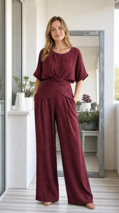Model wearing burgundy wine red two-piece short sleeve twist top and wide leg pants set
