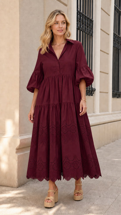 Front view of woman wearing burgundy collared tiered midi dress
