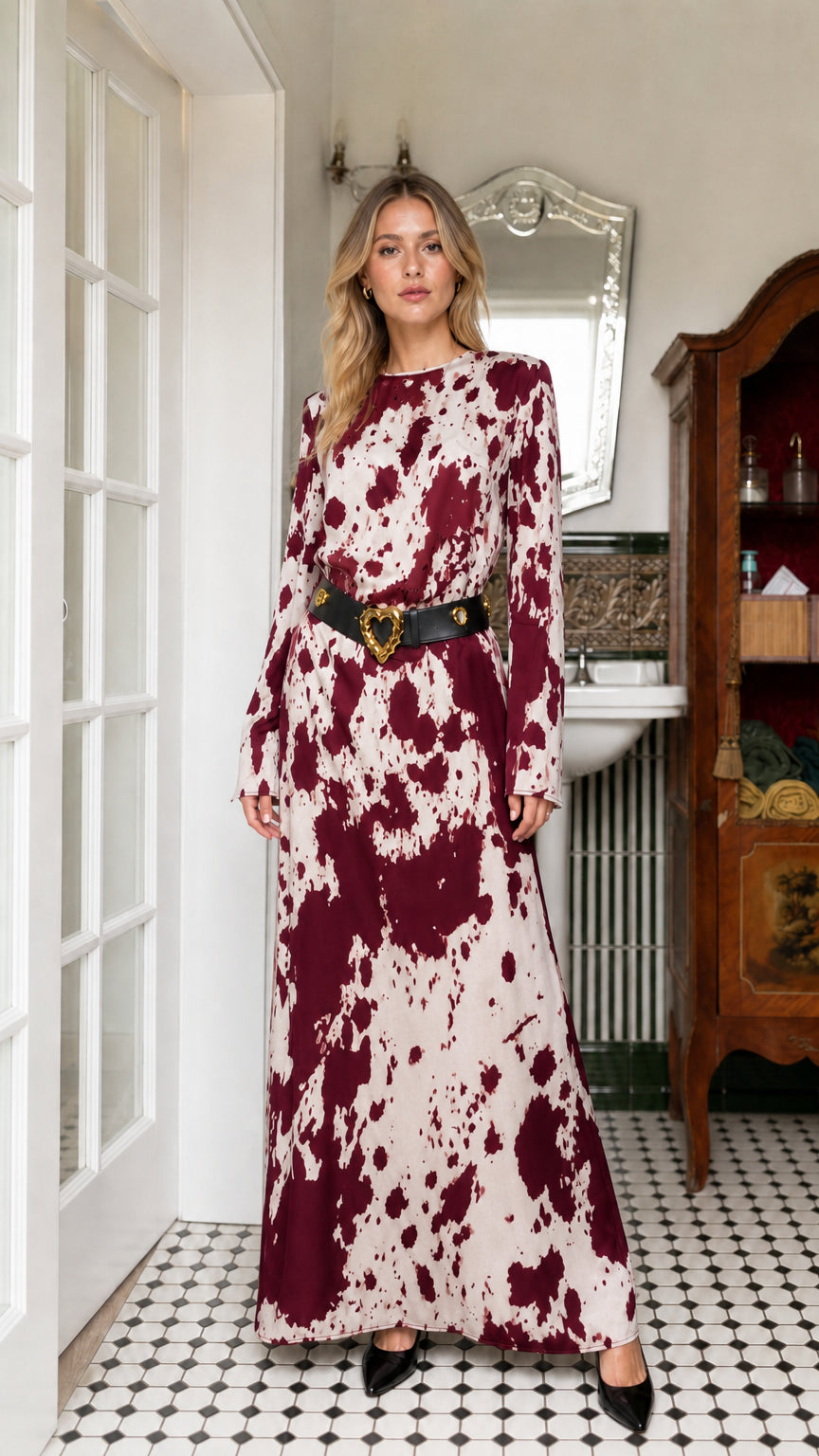 Woman wearing burgundy cow print long sleeve maxi dress with belt