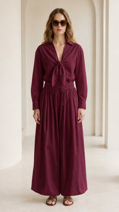 Woman wearing burgundy tie-front shirt and wide-leg pants set