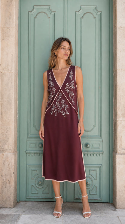 Model wearing burgundy embellished sleeveless midi dress, front view