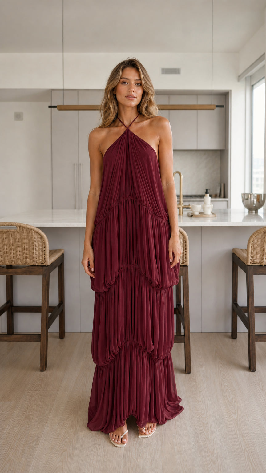 Woman wearing burgundy tiered halter maxi dress
