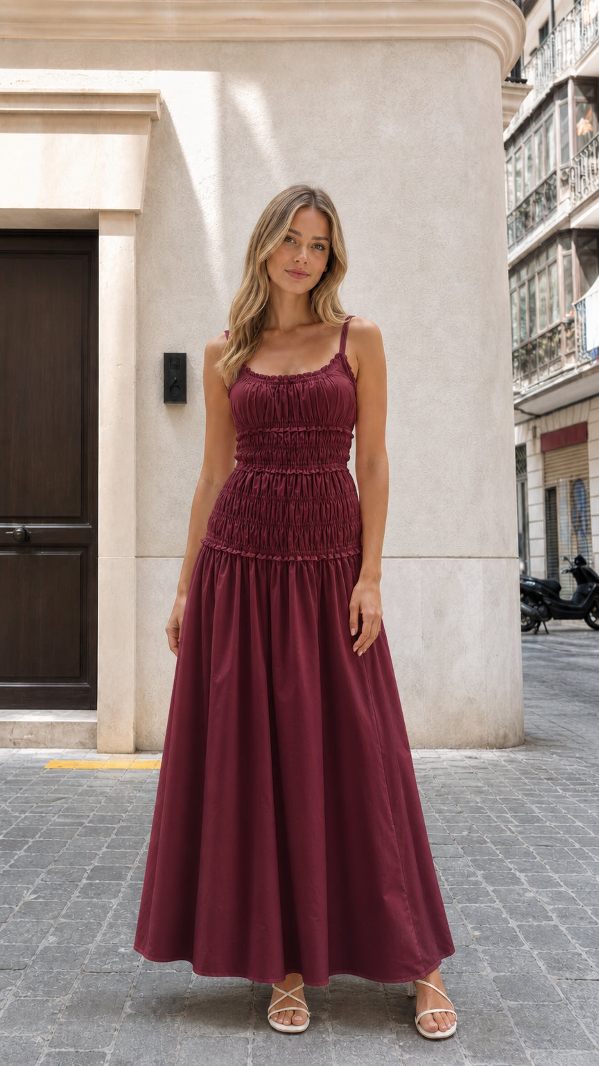 Model wearing burgundy smocked maxi dress front view