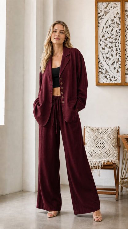 Model wearing burgundy blazer and wide-leg pants set