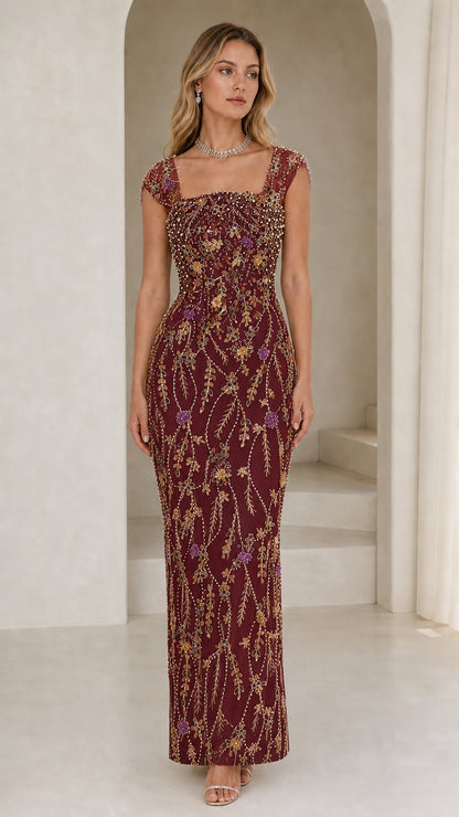 Front view of model wearing burgundy beaded evening gown