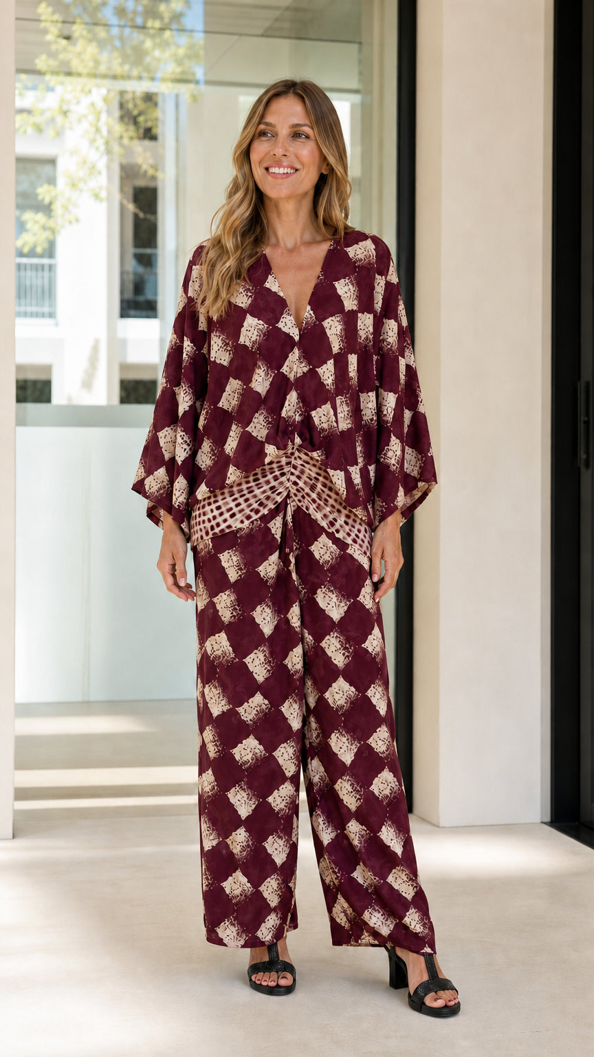 Woman wearing burgundy geometric print two-piece set